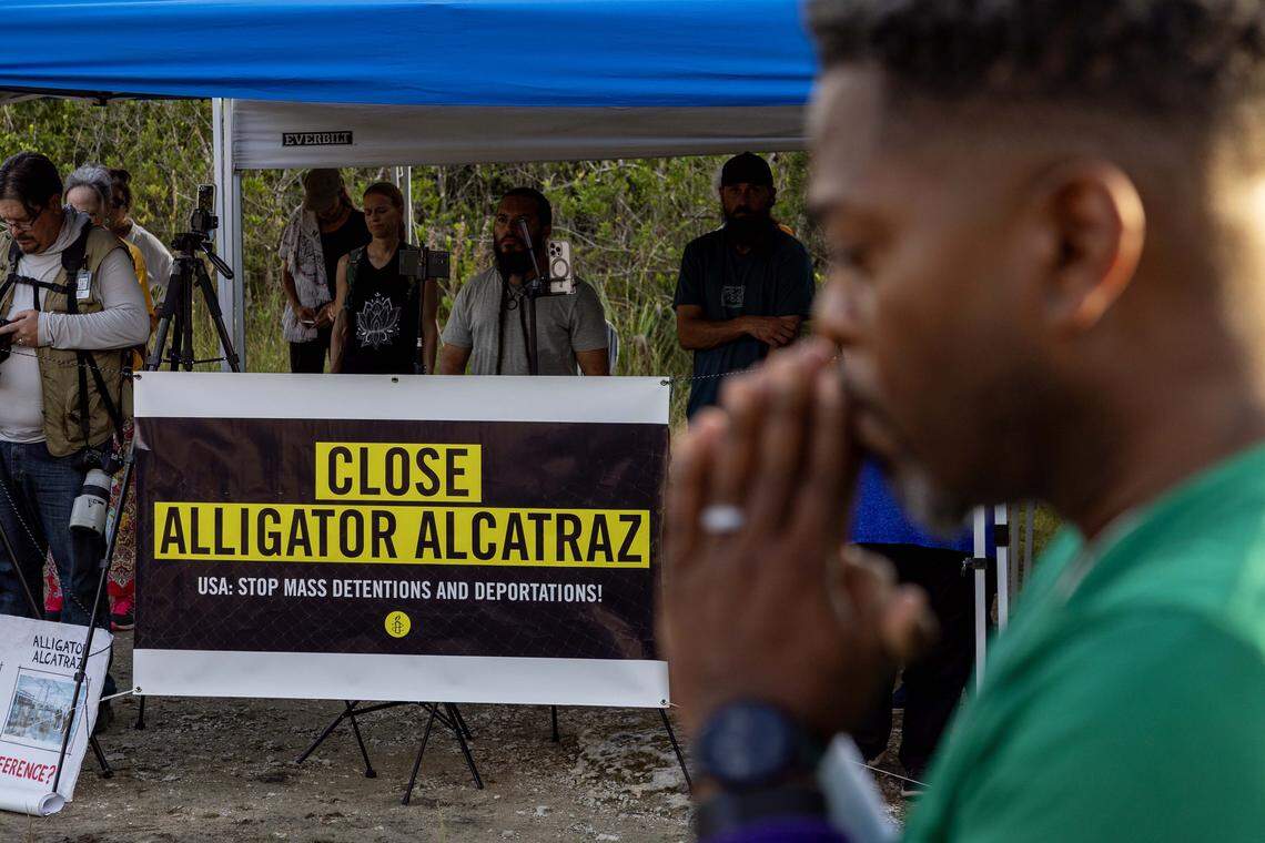 Unitarian Universalist Rev. Arthur Jones holds his hands up in prayer during a vigil outside Alligator Alcatraz on Sunday, October 19, 2025, in Ochopee, Fla.