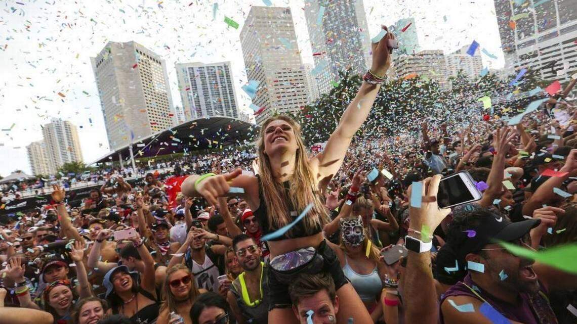 EDM lovers are covered with confetti during one of the daytime performances at Ultra Music Festival.