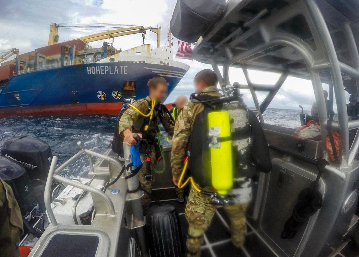 U.S. Border Patrol divers remove a package of cocaine attached to the bottom of a hull of a cargo ship at PortMiami Tuesday, Sept. 23. 2025.