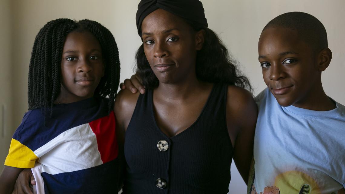 Samya Gordon, 7, left, Sophia Gilbert, 34, and Jahkari Gordon, 12, right, are pictured at their home in Miami’s Model City neighborhood on Saturday, Dec. 7, 2019. The children’s father and Gilbert’s boyfriend, Willie James Gordon, was fatally shot six years ago. Since then, Gilbert has struggled to support her family while working at her children’s charter school.