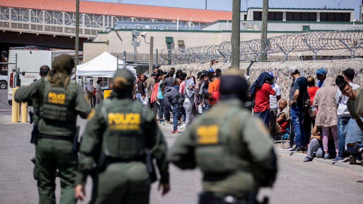 A group of migrants wait to turn themselves into U.S. Customs and Border Protection at the substation at the Paso Del Norte bridge, in El Paso, Texas, Tuesday, May 9, 2023. .