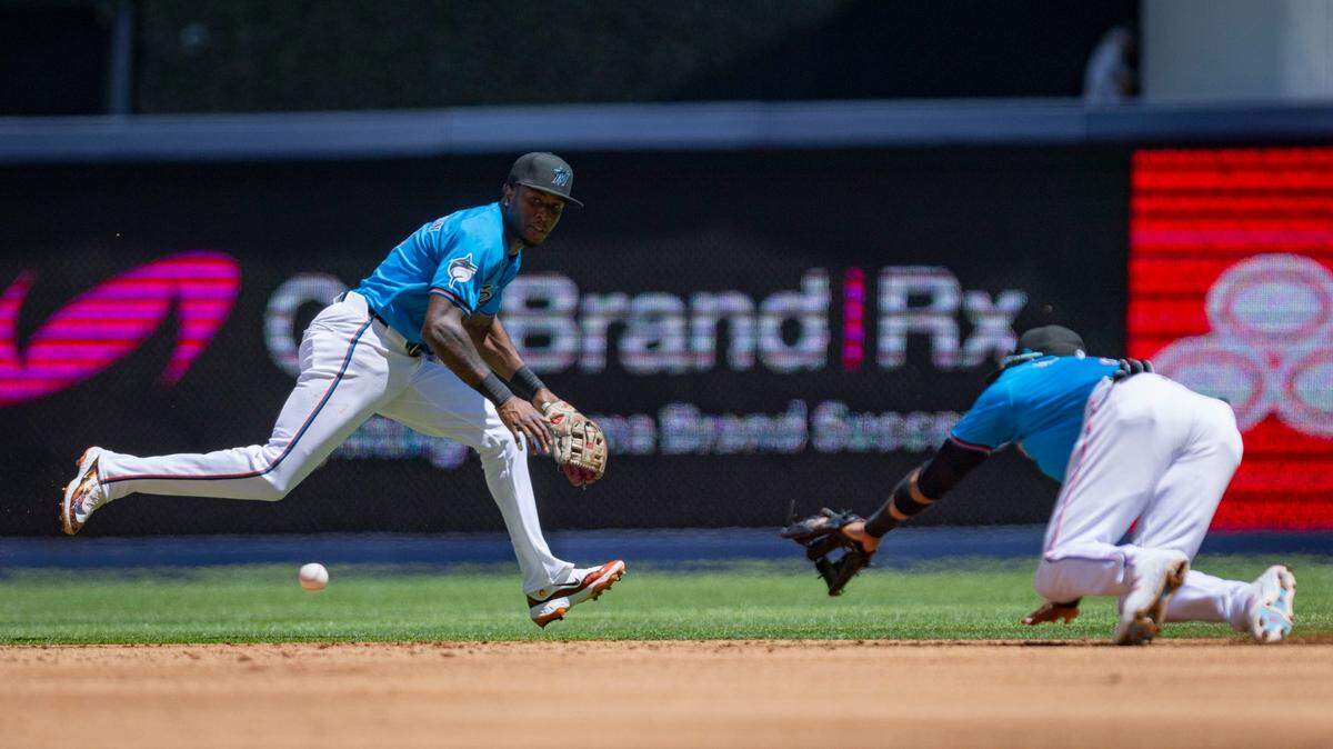 Miami Marlins shortstop Tim Anderson (7) runs after the ball while Miami Marlins second baseman Luis Arraez (3) dives after it during the second inning of a baseball game on Sunday, March 31, 2024, at loanDepot Park in Miami.