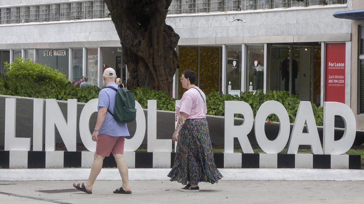People walk past a mix of occupied and vacant shops on Miami Beach’s Lincoln Road Mall, which has seen a downturn in recent years.