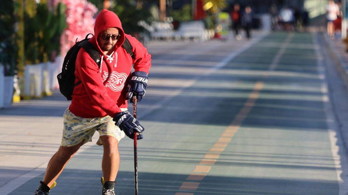 A hockey enthusiast takes advantage of the cool weather and skates with a hockey puck southbound on Ocean Drive as cooler temperatures swept through Miami-Dade. An arctic blast moved into South Florida late Tuesday, bringing a sharp overnight temperature drop. Visitors and residents alike promenade in hoodies, sweaters, coats, and other cold-weather gear on Ocean Drive as breezy north winds made it feel colder through New Year's Eve and New Year's Day. Morning lows were in the upper 40s to low 50s, with daytime highs near the low 70s on Wednesday, December 31, 2025, in Miami Beach, Florida.