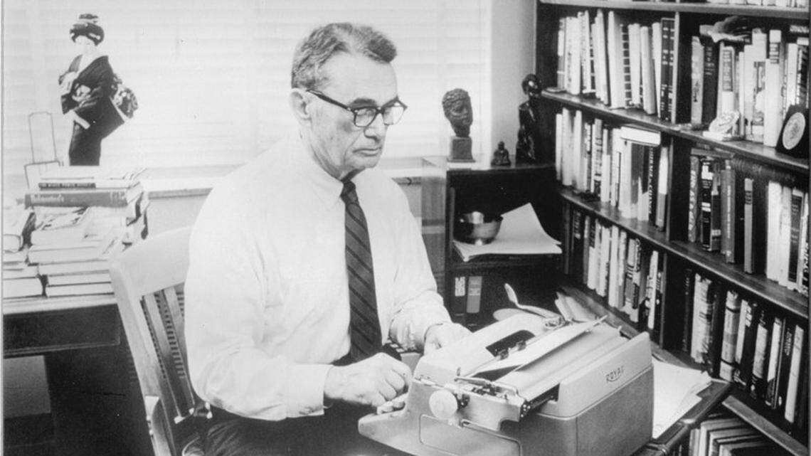 Atlanta Constitution editor Ralph M. McGill writing at his old Royal typewriter.