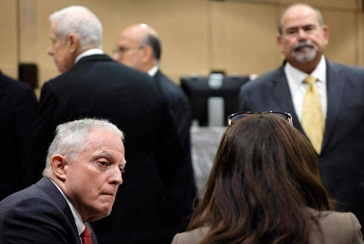 Prosecutors Steven Klinger and Nicole Bloom speak as defense attorneys are shown behind during a recess in a hearing as part of the trial of Jamell Demons, better known as rapper YNW Melly, at the Broward County Courthouse in Fort Lauderdale on Friday, Oct. 6, 2023. (Amy Beth Bennett / South Florida Sun Sentinel)
