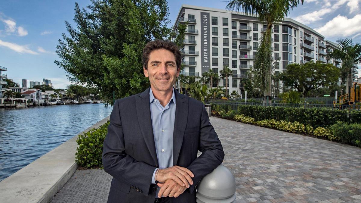 Camilo Miguel Jr. stands along the river walk at the Waterline Miami River apartment complex on Thursday, Sept. 23, 2021. Miguel is the CEO and founder of Mast Capital, a firm with a portfolio of more than $2 billion.