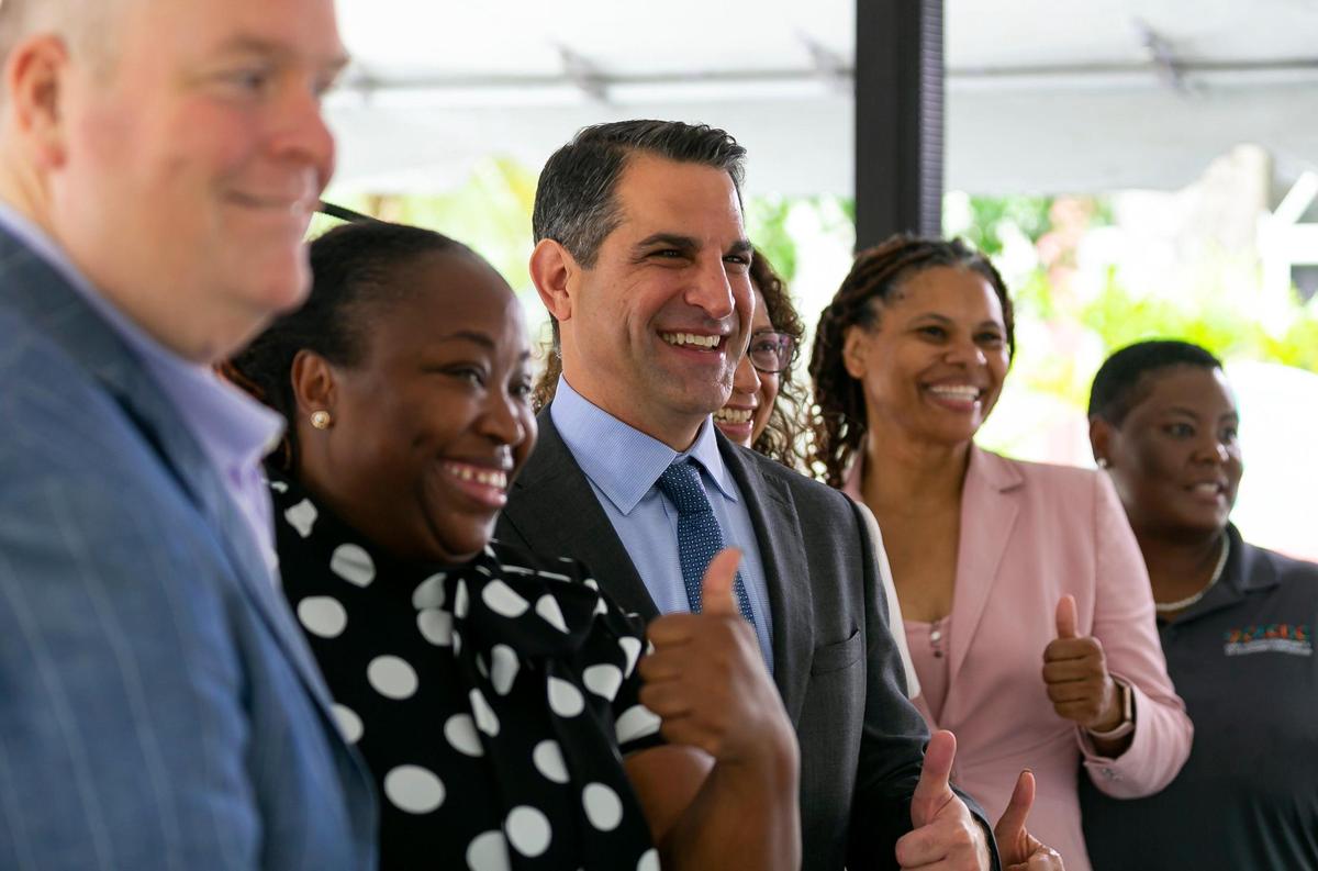 James R. Haj, center, the president and CEO of The Children’s Trust, celebrates with other community leaders at the Opa-locka Community Development Corporation Alice Brown Apartments on Tuesday, June 14, 2022, in Opa-locka. The Children’s Trust announced its board approved a $14 million investment in its Family and Neighborhood Support Partnerships, which will help South Florida families in need.