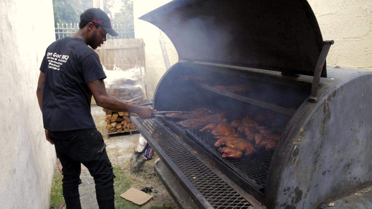 Miami, June 7, 2019 - Pierry Saintjoy works the girl at Bon Gout Barbecue as he and the crew prepare to open for business. Bon Gout Barbecue, 99 NW 54th St, Little Haiti