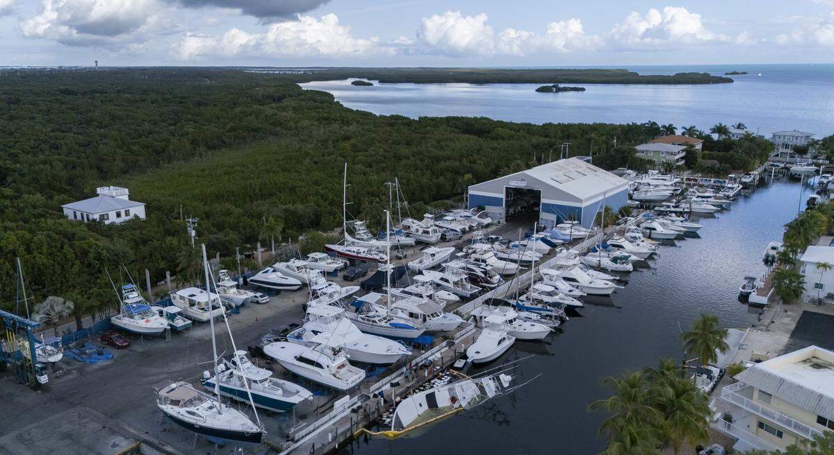 Aerial view of a 55-foot yacht that is leaking diesel and is partially submerged at Key Largo Harbor Marina on Wednesday, Dec. 10, 2025, in Key Largo, Fla.