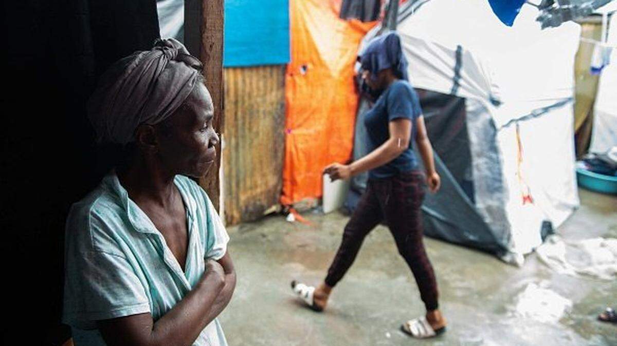 A woman stands in a temporary shelter after heavy rains affected the city of Port-au-Price, in Haiti, on April 13, 2025. Haiti, the poorest nation in the Americas, was plunged into fresh unrest last year when gangs launched coordinated attacks in Port-au-Prince to force then prime minister Ariel Henry to resign. More than 60,000 people have been displaced in one month in Haiti's capital Port-au-Prince which is "under siege" from a resurgence in gang violence ravaging the country, United Nations migration agency IOM said on March 18. (Photo by Clarens SIFFROY / AFP) (Photo by CLARENS SIFFROY/AFP via Getty Images)