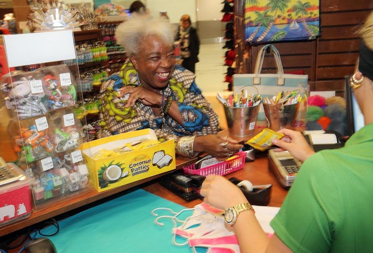 Carole Ann Taylor, founder and owner of Cultures to Go, buys some items at her store Miami To Go at Miami International Airport.