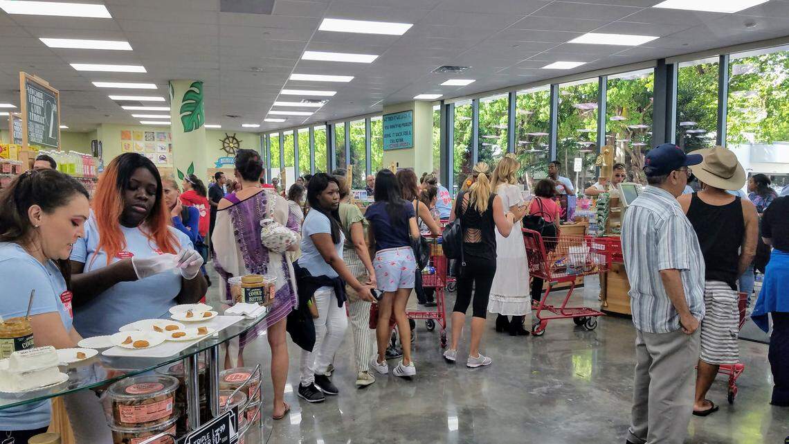 Customers line up to pay for organic berries and free trade coffee at Trader Joe’s.