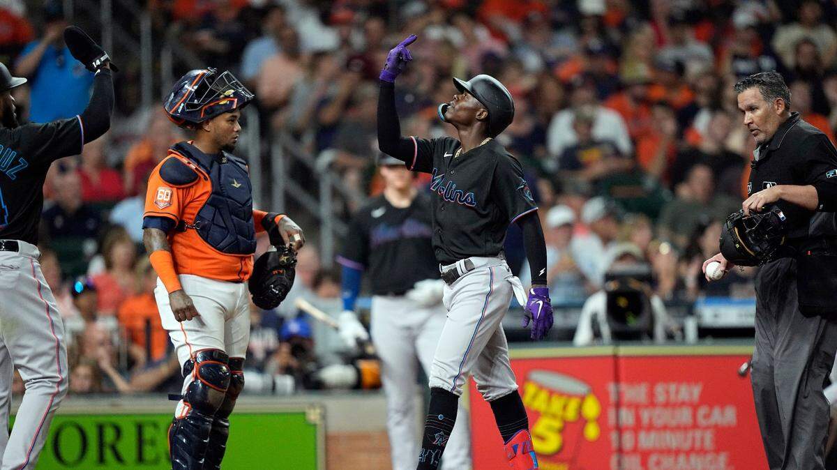 Miami Marlins’ Jazz Chisholm Jr., center, celebrates after hitting a two-run home run as Houston Astros catcher Martin Maldonado looks on during the fifth inning of a baseball game Friday, June 10, 2022, in Houston. (AP Photo/David J. Phillip)