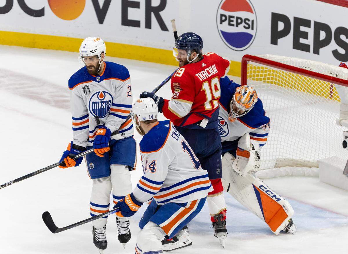 Edmonton Oilers defenseman Evan Bouchard (2) and Oilers defenseman Mattias Ekholm (14) helps Oilers goaltender Stuart Skinner (74) defend the net against pressure from the Florida Panthers left wing Matthew Tkachuk (19) during the second period of Game 5 of the NHL Stanley Cup Final at the Amerant Bank Arena on Tuesday, June 18, 2024, in Sunrise, Fla.