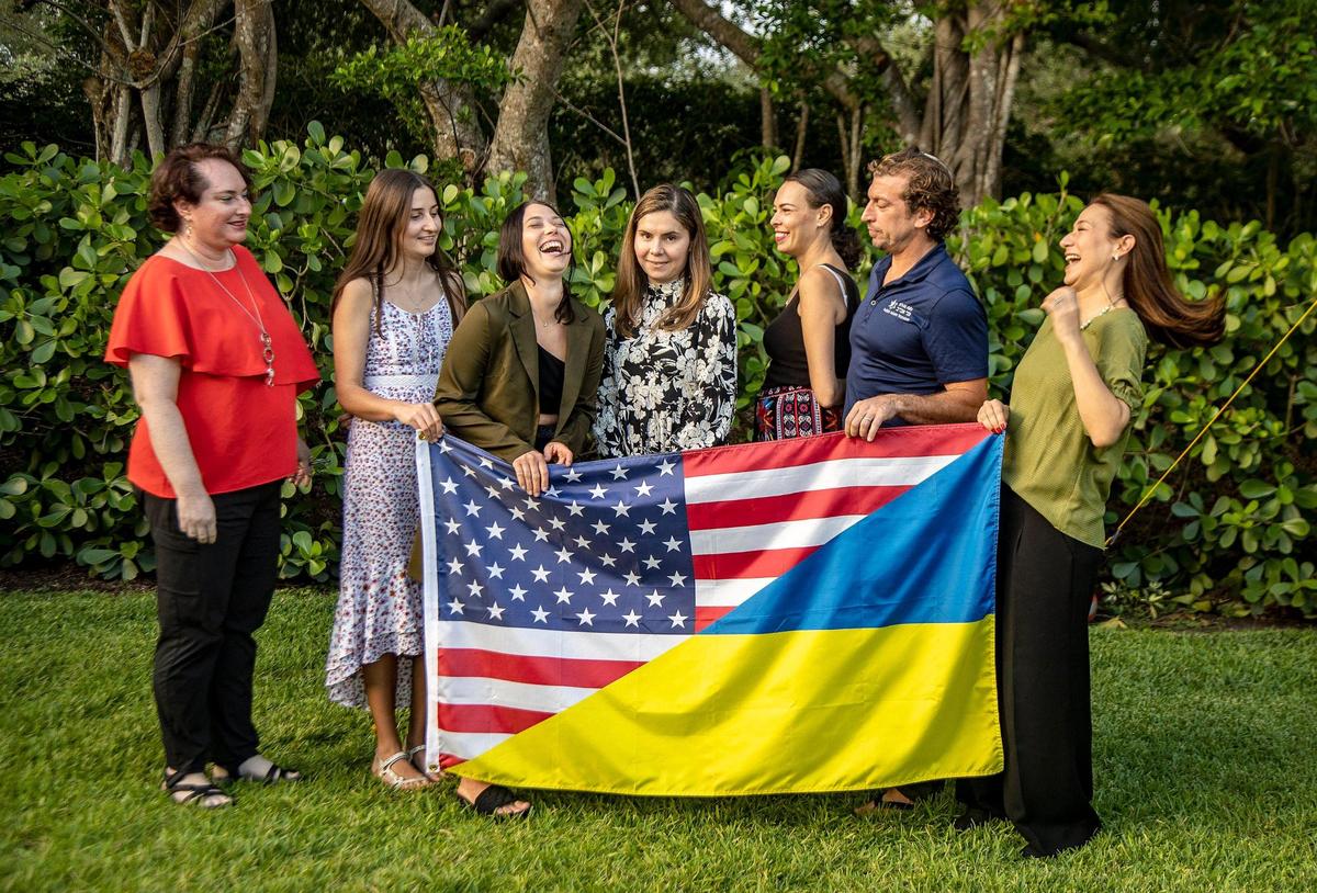 A group of volunteers helping to relocate Ukrainian families displaced by the Russian invasion share at the home of Angie Watstein and her husband, Rabbi Adam Watstein (third and second from right) of the temple B’nai Aviv, who are hosting Anastasia Sibiriakova (third from left), a member of a Ukrainian refugee family in Weston. From left, Michelle Diamond, Kateryna Tserkovniuk, with the St. Nicholas Ukrainian Orthodox Church of Cooper City, Anastasiia Sibiriakova, Juliet Bedard, with St. Nicholas, Angie and Rabbi Adam Watstein, and Vanessa Siberberg, on Wednesday, May 4, 2022.