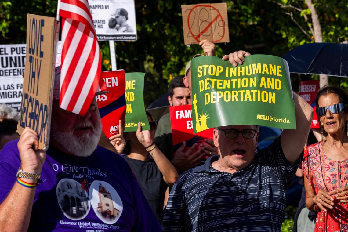 Demonstrators wave signs that read “STOP INHUMANE DETENTION AND DEPORTATION” during a press conference hosted by ACLU Florida, Florida Rising, the Florida Immigrant Coalition and Family Action Network Movement on Tuesday, June 17, 2025, in Miami.