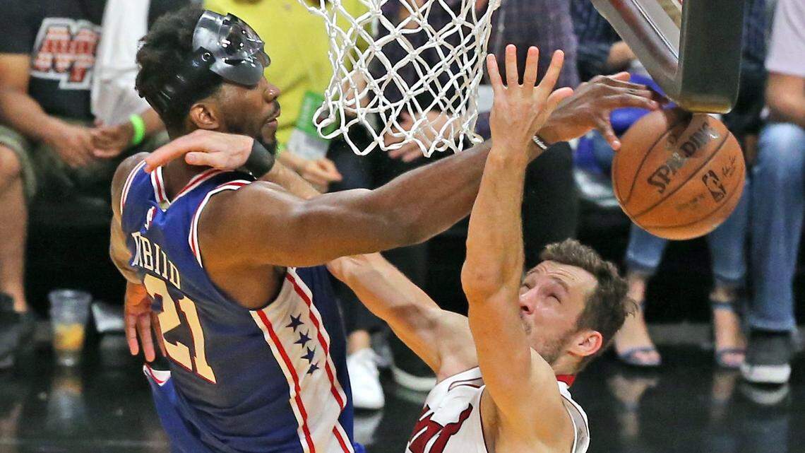 The Miami Heat's Goran Dragic is blocked by the Philadelphia 76ers' Joel Embiid late in the fourth quarter in Game 4 of the first-round NBA playoff series at the AmericaneAirlines Arena in Miami, Florida, April 21, 2018.