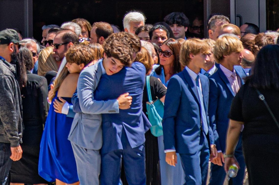 People hug each other after Lucy Fernandez’s funeral Mass at the Church of the Epiphany in the South Miami area on Monday, Sept. 12, 2022.
