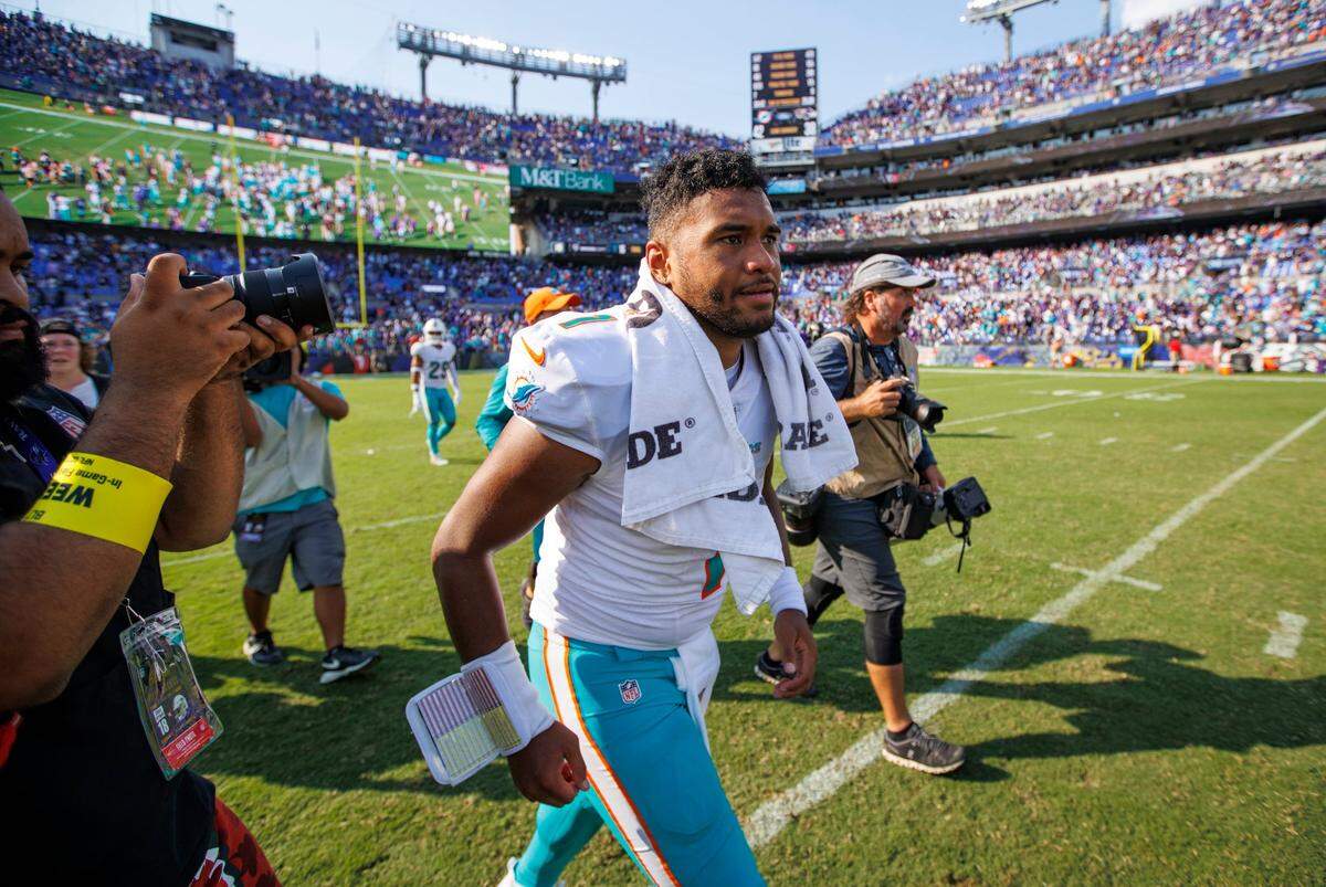 Miami Dolphins quarterback Tua Tagovailoa (1) runs out the field after their 42-38 win over the Baltimore Ravens during an NFL football game at M&T Bank Stadium on Sunday, September 18, 2022 in Baltimore, MD.