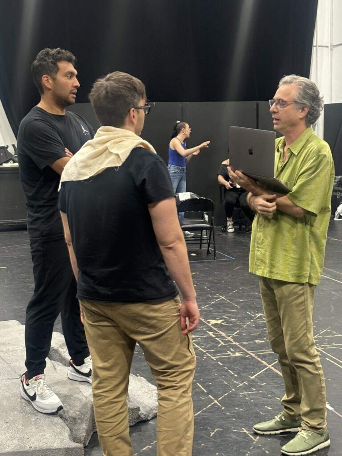 Director Jeffrey Marc Buchman works with tenor Ricardo Garcia, left, who sings Tamino and Alex DeSocio who plays Papageno in the Florida Grand Opera production of Mozart’s “The Magic Flute.”