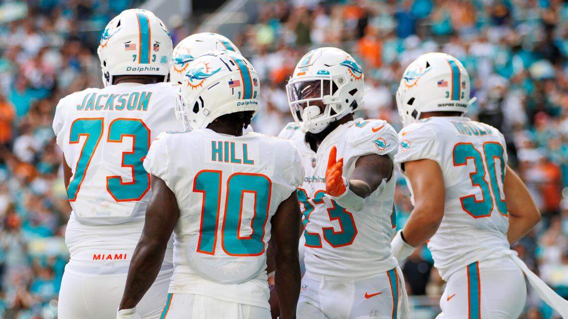 Miami Dolphins running back Jeff Wilson Jr. (23) celebrate with teammates after scoring a touchdown during second quarter of an NFL football game against the Houston Texans at Hard Rock Stadium on Sunday, November 27, 2022 in Miami Gardens, Florida.