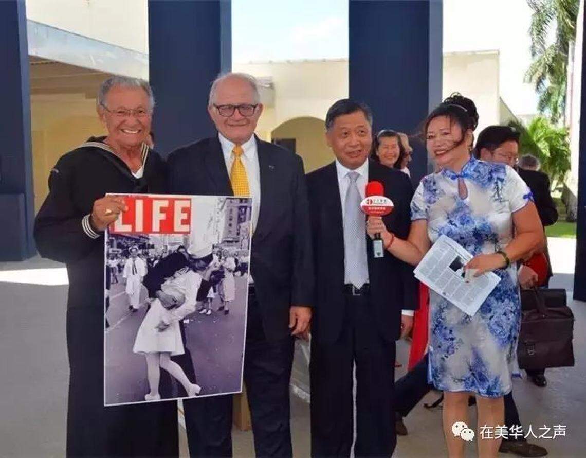 Li ‘Cindy’ Yang (right) is shown appearing to interview Florida International University President Mark Rosenberg (second from left) and Li Qiangmin, China’s consul general in Houston (second from right), at an October 2015 event held at FIU commemorating China’s role in World War II.