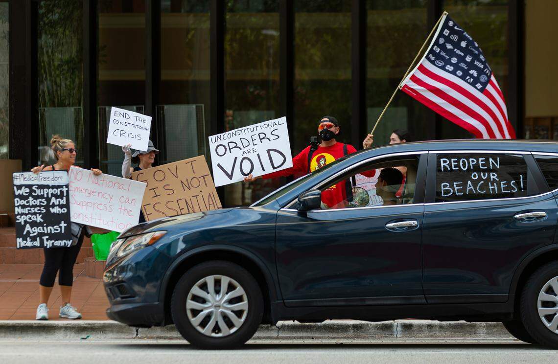 Protestors with the Reopen South Florida Group host a demonstration outside of the Broward County Governmental Center during a commission meeting on Tuesday, May 19, 2020. Commission meetings are currently closed to the public due to the coronavirus restrictions officials have put into place.