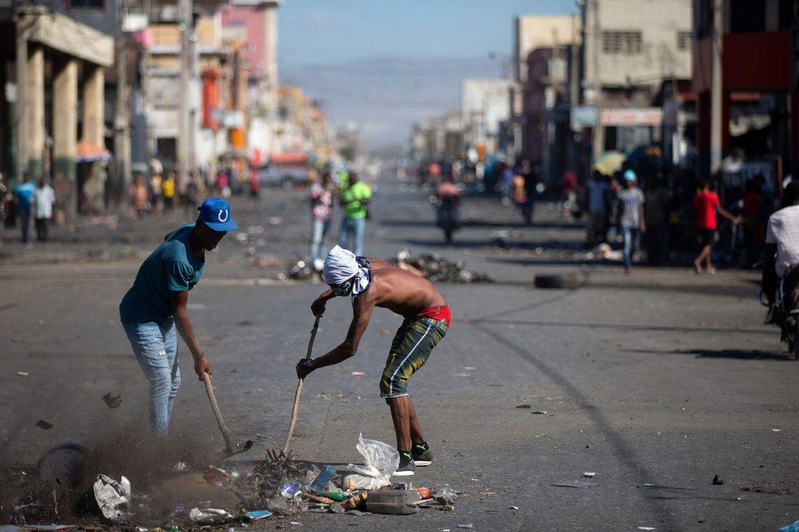Residents clear a place to play soccer in a street devoid of cars due to a countrywide transportation strike.