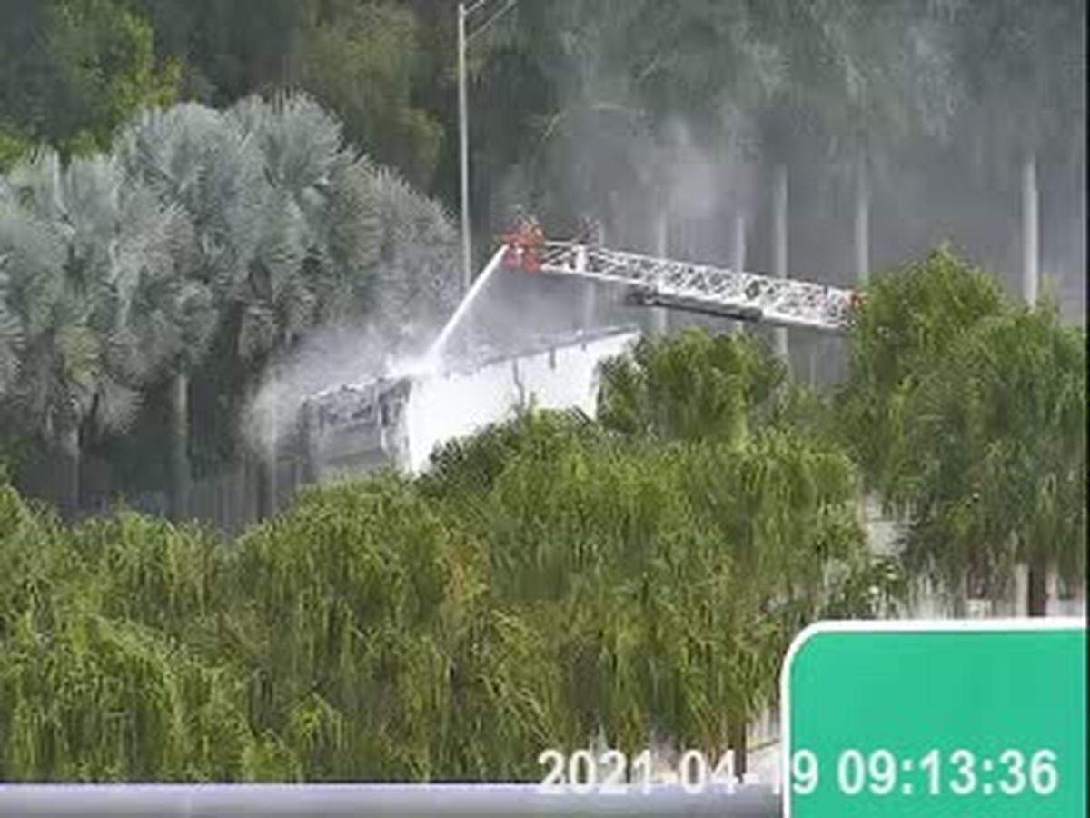 Fire rescue workers douse the semi-truck on fire along the Sawgrass Expressway Monday morning.