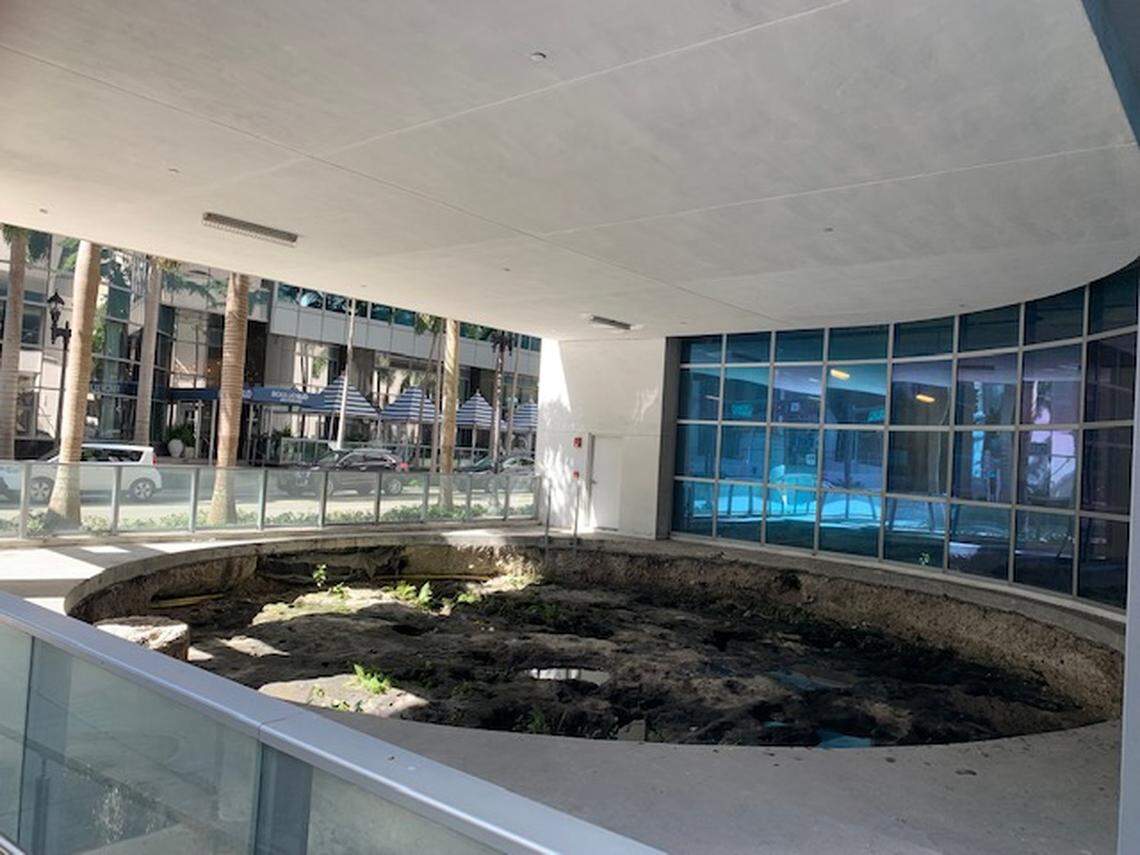 A preserved ancient Tequesta posthole circle that developer MDM promised to enclose in glass and exhibit at its MetSquare complex instead sits open to the air with no signage to indicate its significance. The City of Miami says the lack of enclosure violates a 2014 legal agreement.