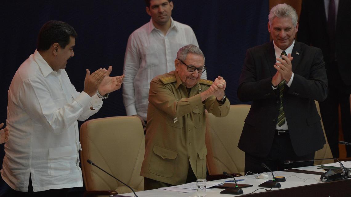 The First Secretary of the Cuban Communist Party, Cuban former President Raúl Castro (C), gestures during the commemoration of the 14th anniversary of Bolivarian Alliance for the Peoples of Our America Peoples’ Trade Treaty (ALBA-TCP) as Venezuelan President Nicolás Maduro (L) and Cuban President Miguel Díaz-Canel applaud, during the XVI ALBA-TCP Summit, at the Convention Palace in Havana, on December 14, 2018.