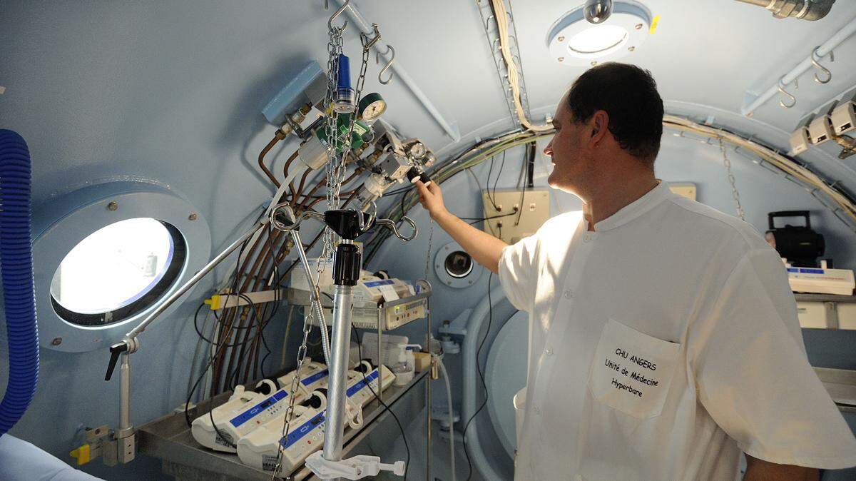 A technician prepares a hyperbaric chamber in an intensive care unit at the CHU Angers teaching hospital in Angers, western France, on October 24, 2013.
