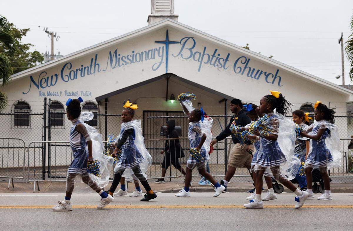 Holmes Elementary School cheer squad walks in the Dr. Martin Luther King Jr. Day parade on Monday, Jan. 20, 2025, in Liberty City in Miami, Fla.