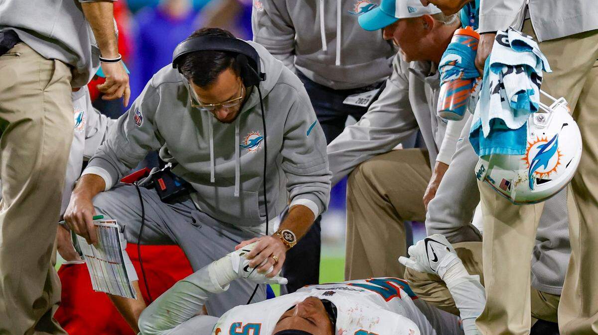 Miami Dolphins head coach Mike McDaniel tends to Miami Dolphins linebacker Cameron Goode (53) after an injury during the game against the Buffalo Bills in the fourth quarter at Hard Rock Stadium in Miami Gardens on Sunday, January 7, 2024.