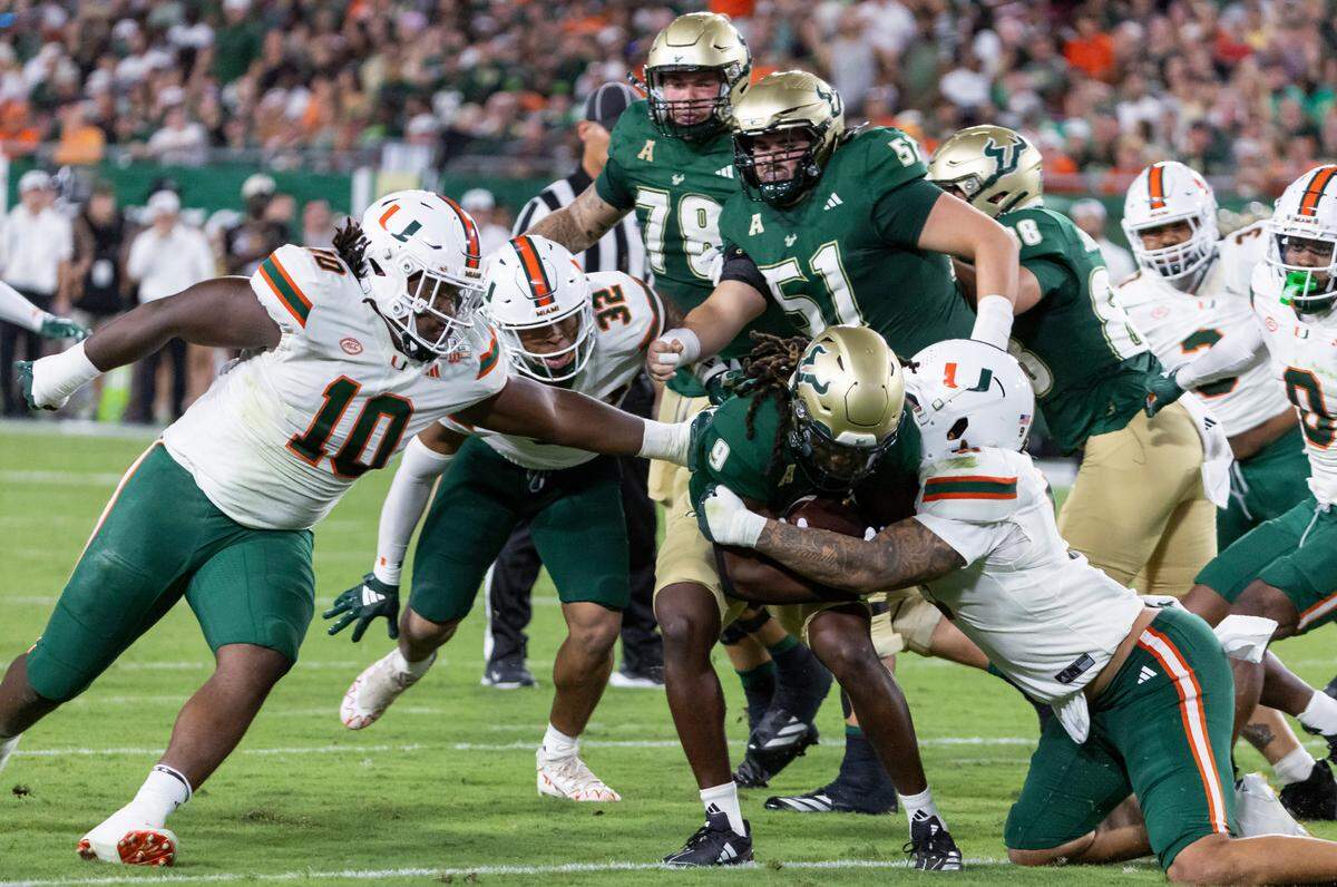 Miami Hurricanes defensive lineman Tyler Baron (9) tackles South Florida Bulls running back Ta’Ron Keith (9) in the first half of their NCAA college football game at the Raymond James Stadium on Saturday, Sept. 21, 2024, in Tampa, Fla.