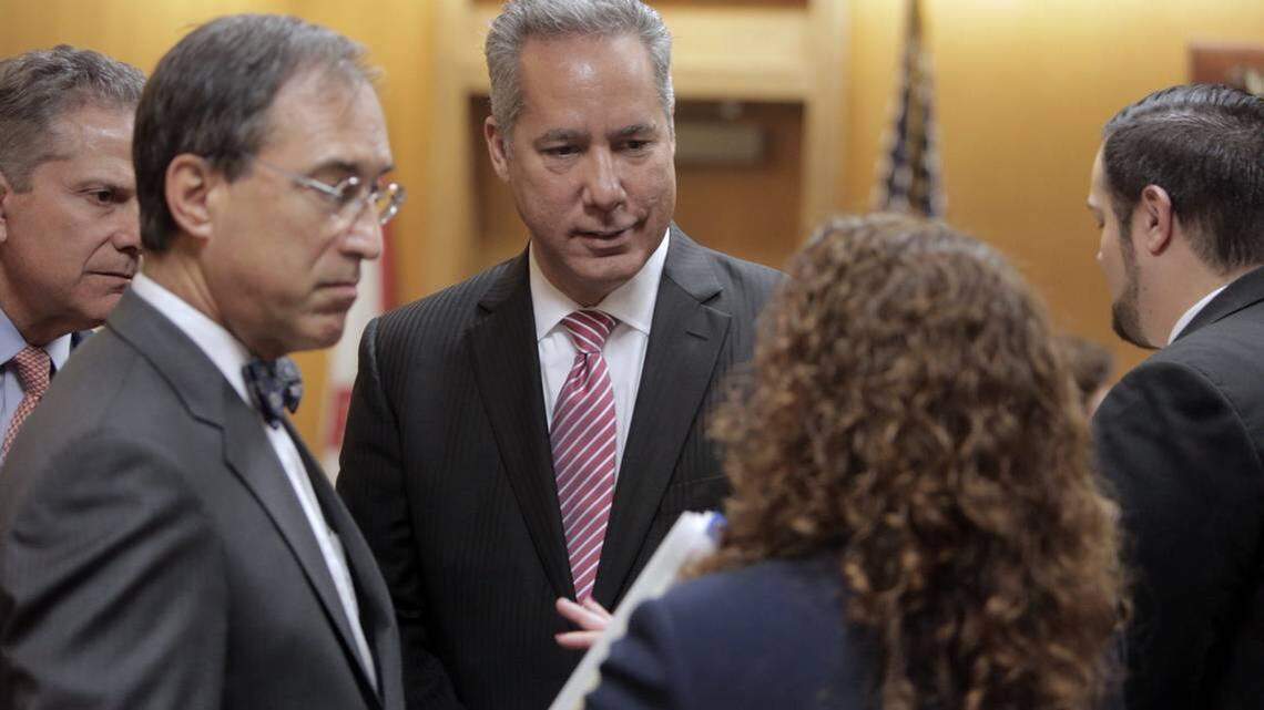 North Miami Beach Mayor George Vallejo (center) gathers with his attorneys in court on April 10. Vallejo pleaded guilty to a campaign finance violation as part of a plea deal worked out in advance and resigned from office.