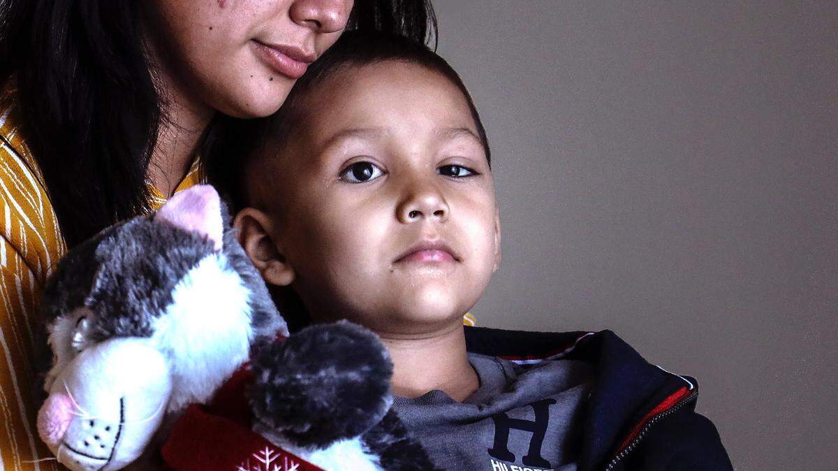 Yesenia Alvarenga sits with her son, Jayden, at her attorney’s office in Coconut Grove. Alvarenga is suing Dr. Timothy Murray, Nicklaus Children’s Hospital and Dr. Ziad Khatib, claiming their failure to properly treat her son’s retinoblastoma allowed the cancer to spread through his body.