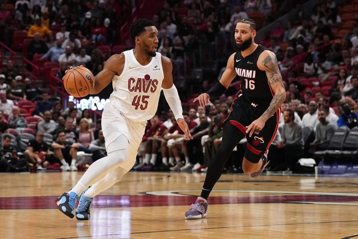 Cleveland Cavaliers guard Donovan Mitchell (45) drives the ball around Miami Heat forward Caleb Martin (16) during the second half at Kaseya Center.