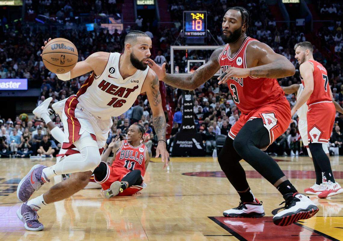 Miami Heat forward Caleb Martin (16) drives the ball as Chicago Bulls center Andre Drummond (3) defends in the second half at FTX Arena on Wednesday, October 19, 2022.