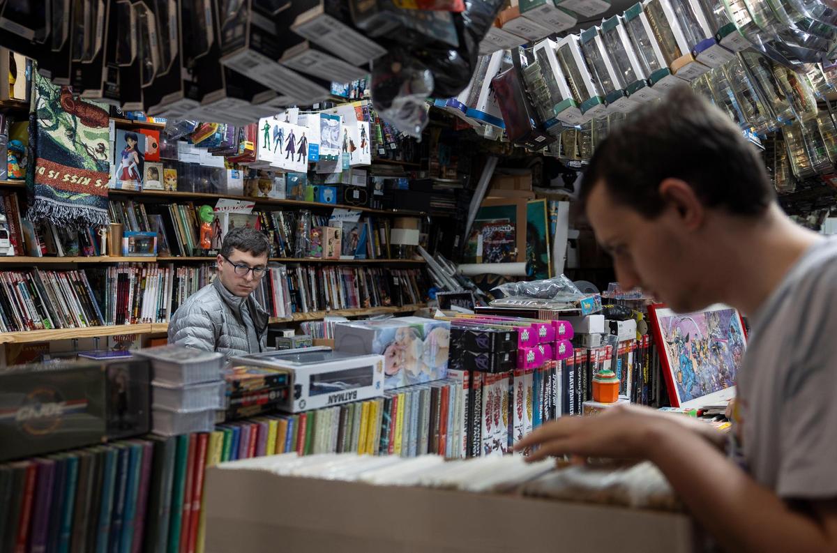 Customers Jake Berger, 27, left, and Tucker Owens, 20, right shop at A&M Comics and Books on Friday, Jan. 24, 2025, in Miami, Fla.