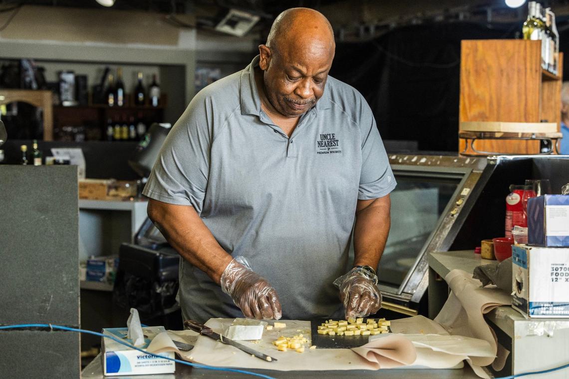 Sunset Corners’ David McGriff prepares the cheeses and hors d’oeuvre for the Saturday, June 1, 2024, wine tasting at the landmark family business at 8701 Sunset Dr., in Miami.