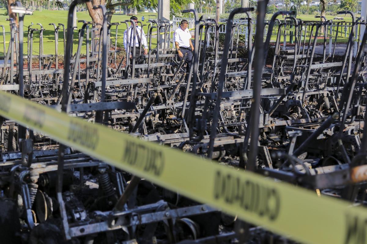 Miami Fire Rescue officials assess damage after a few dozen golf carts were destroyed in a fire at Melreese Country Club on Wednesday, July 25, 2018. Rescue crews responded to the fire late Tuesday night.