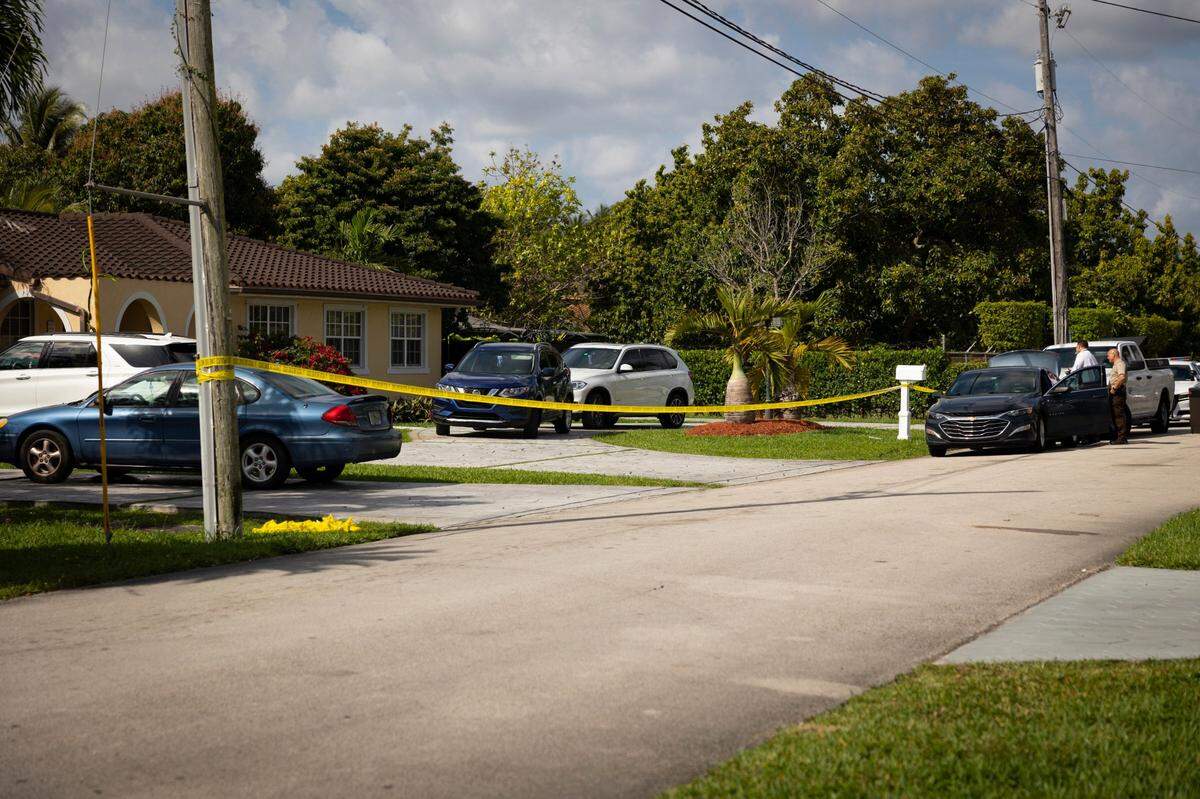 Miami-Dade police officers cordoned off a home where investigators say a man shot and killed himself near Miami, Florida, Wednesday, March 13, 2024.