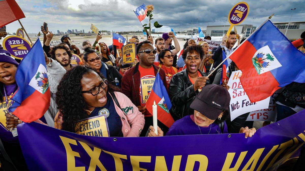 Protesters gather during a candlelight vigil and interfaith prayer at Fort Lauderdale-Hollywood International Airport on Jan. 28 2026, calling on the Trump Administration to extend Temporary Protected Status for Haitians. 