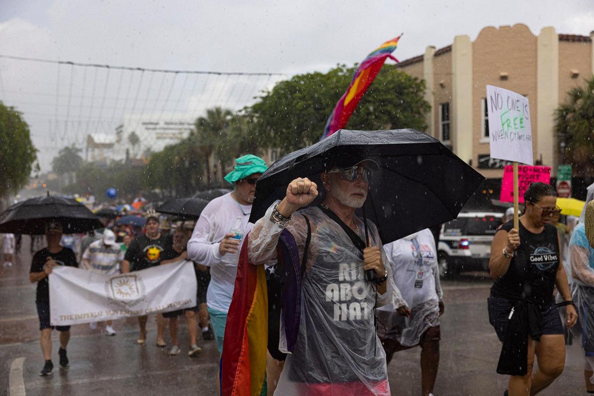 Robert Miller, from Lake Worth, marches with his fist up during an Anti-Hate March led by We the People on Sunday, July 2, 2023, in downtown Fort Lauderdale.