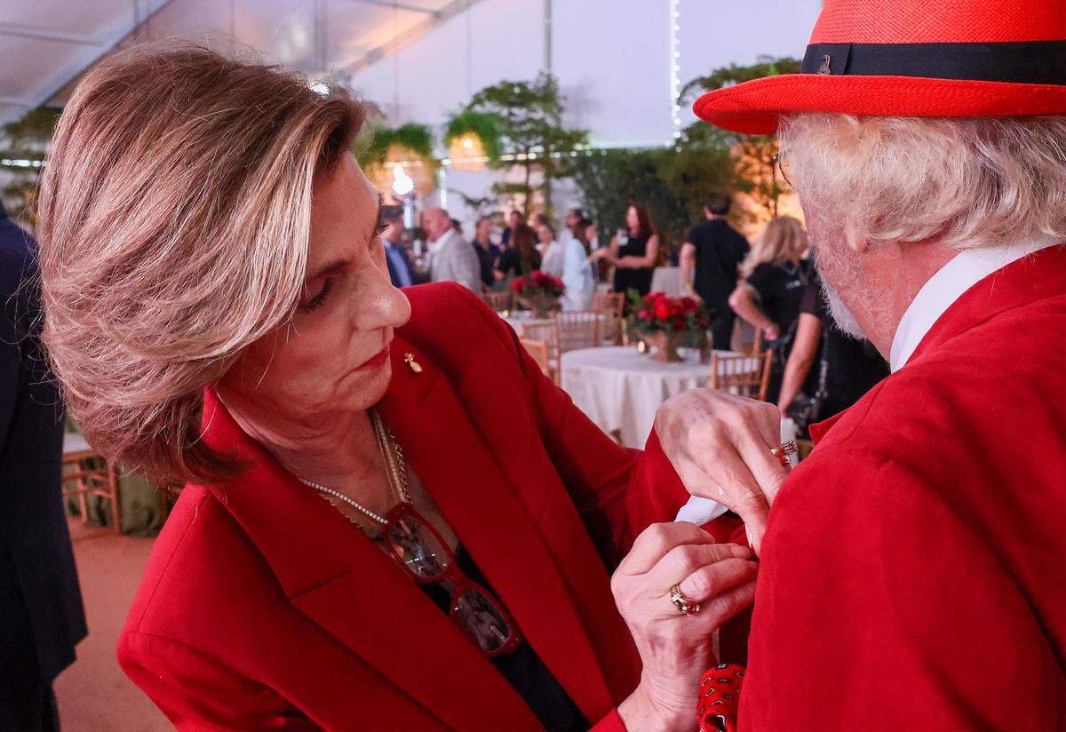 CEO Baptist Health Foundation Alex Villoch carefully places the Baptist Health pin on the lapel of Dr. Herbert Wertheim's red jacket. Baptist Health South Florida and the Baptist Health Foundation announced the largest single philanthropic gift in the organization's 66-year history from Dr. Herbert Wertheim during a celebration of the donation and Wertheim's upcoming birthday at Baptist Health in Kendall, Wednesday, May 20, 2026, in Miami, Florida.Attendees donned red hats-a signature of Dr. Wertheim-in tribute to his visionary philanthropy and in recognition of his lasting impact on the Baptist Health and FIU. 