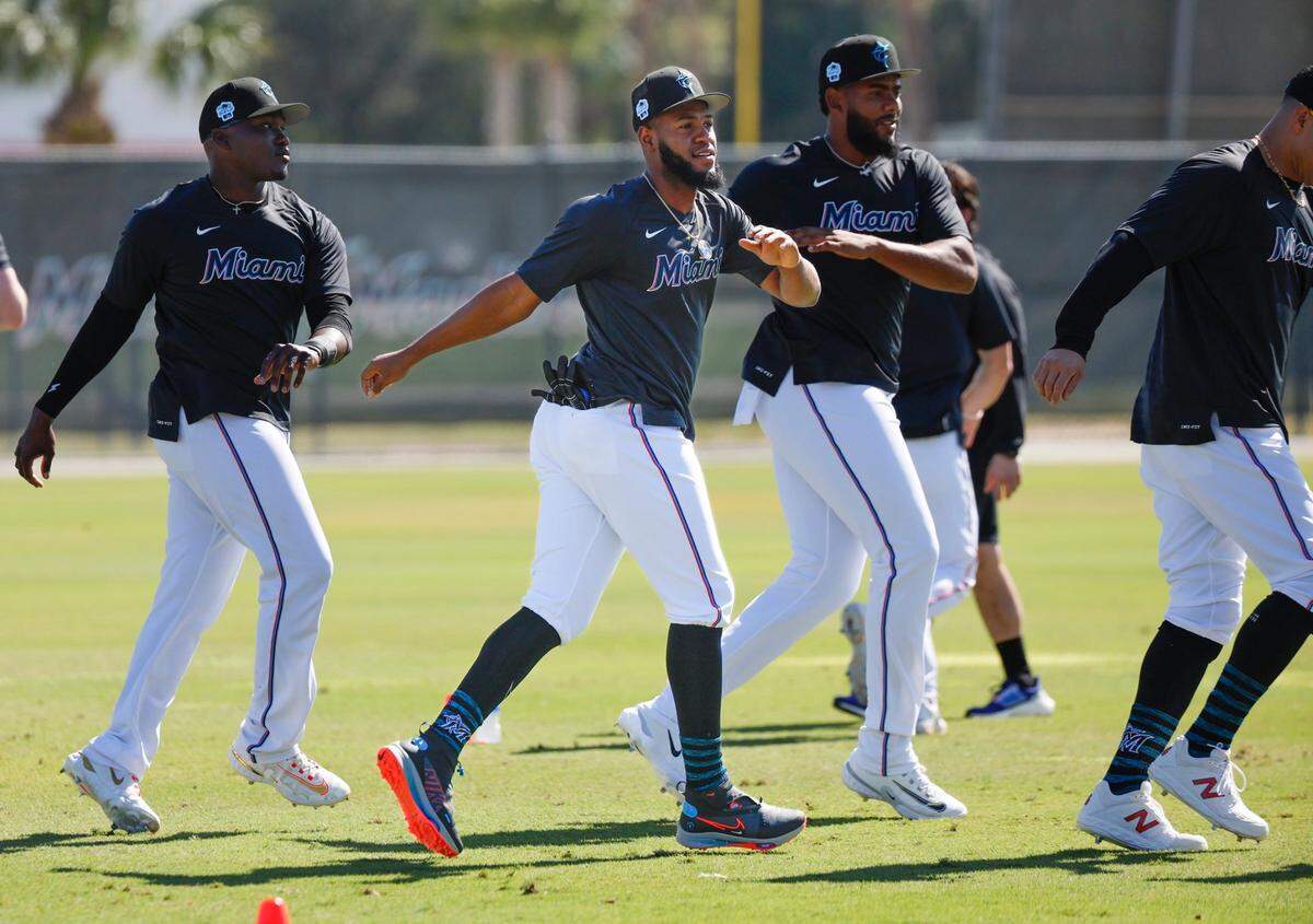 Miami Marlins outfielder Bryan De La Cruz (center) stretches prior to a spring training workout at Roger Dean Chevrolet Stadium in Jupiter, Florida on Tuesday, February 21, 2023.