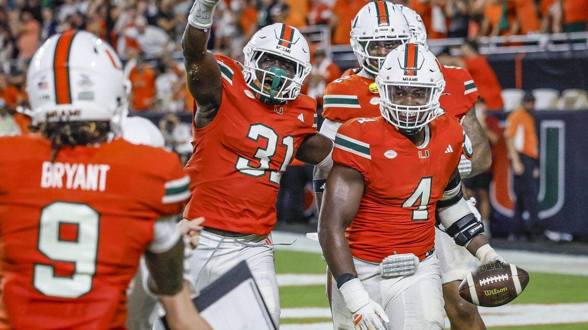 Miami Hurricanes defensive lineman Rueben Bain Jr. (4) celebrates with teammates after intercepting the ball in the fourth quarter during an NCAA football game Notre Dame Fighting Irish at Hard Rock Stadium in Miami Gardens, Florida, on Sunday, August 31, 2025.