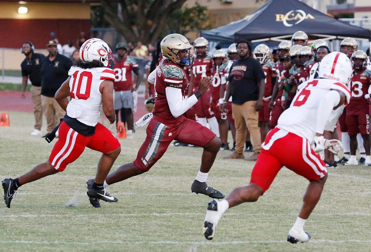 Coconut Creek Cougars quarterback James Hayes carries the ball against Plantation Colonels during the football game on Thursday, September 4, 2023 at Coconut Creek.